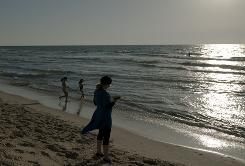 Photo Credit: David Buimovitch, AFP/Getty Images; Description: During the 10 days between Rosh Hashanah and and the Day of Atonement, Yom Kippur, Jewish people reflect on the sins of the past year and let go of their guilt with prayers and rituals such as the one shown here where a Jewish woman follows the tradition of going to a to a flowing body of water to symbolically "throw away" sins. 